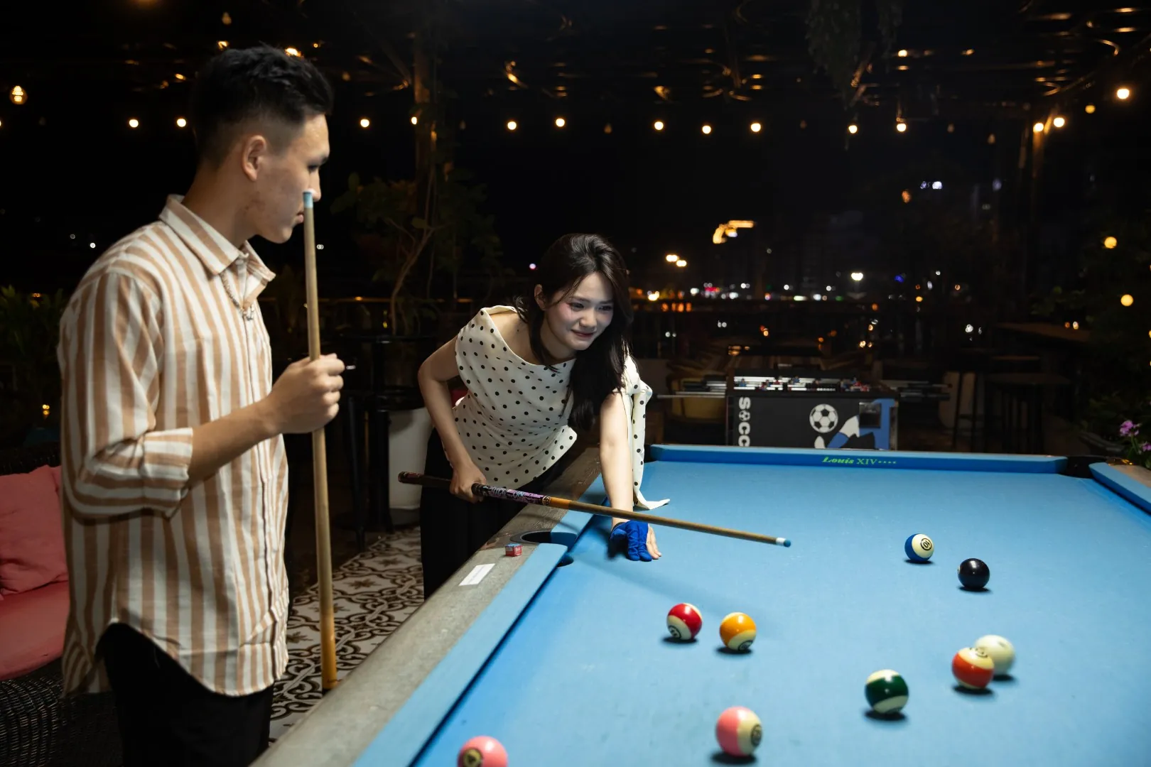 Playing pool on the Roza Bar rooftop in Cat Ba at night